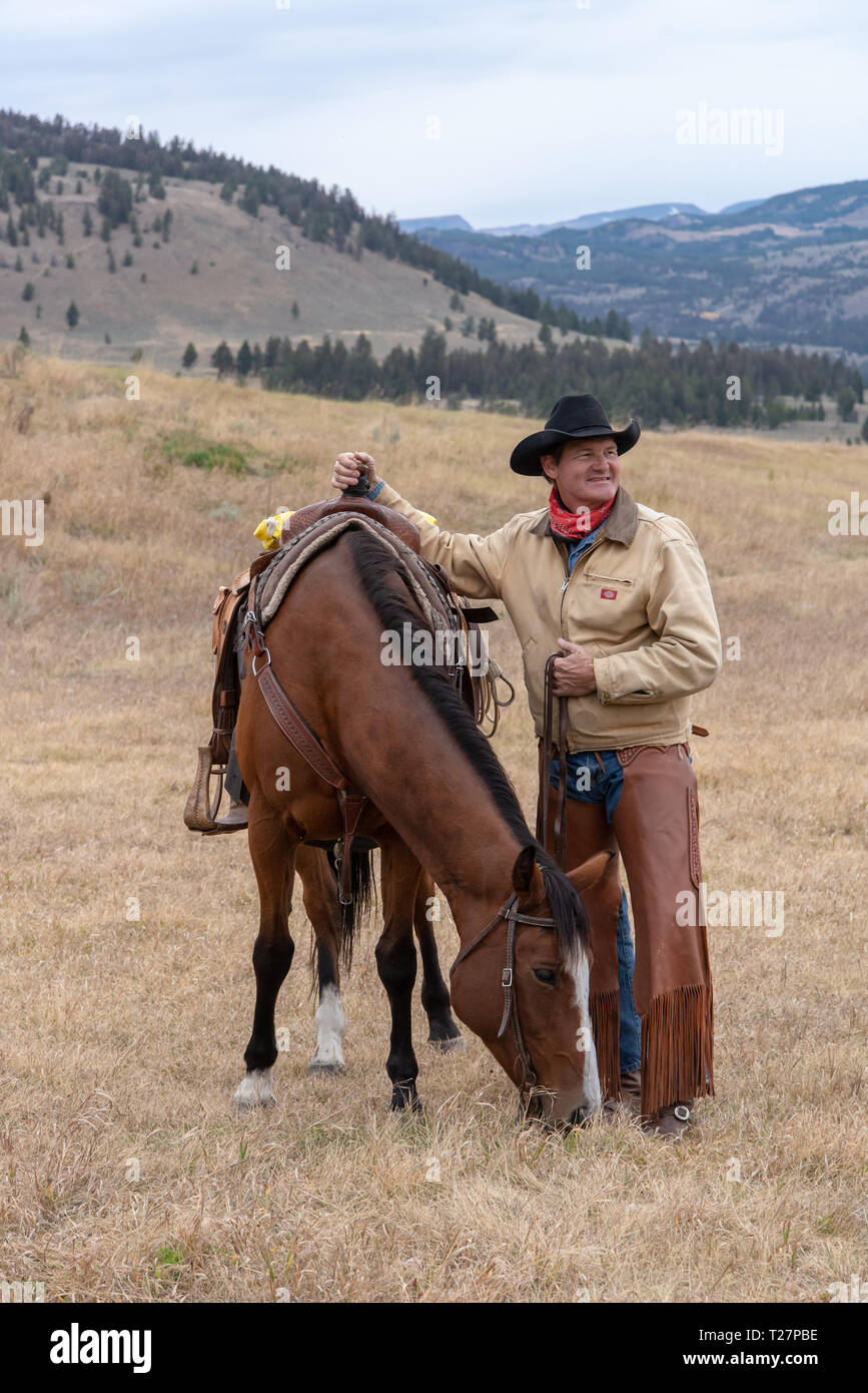 Cowboy and his horse in the high country of Wyoming Stock Photo