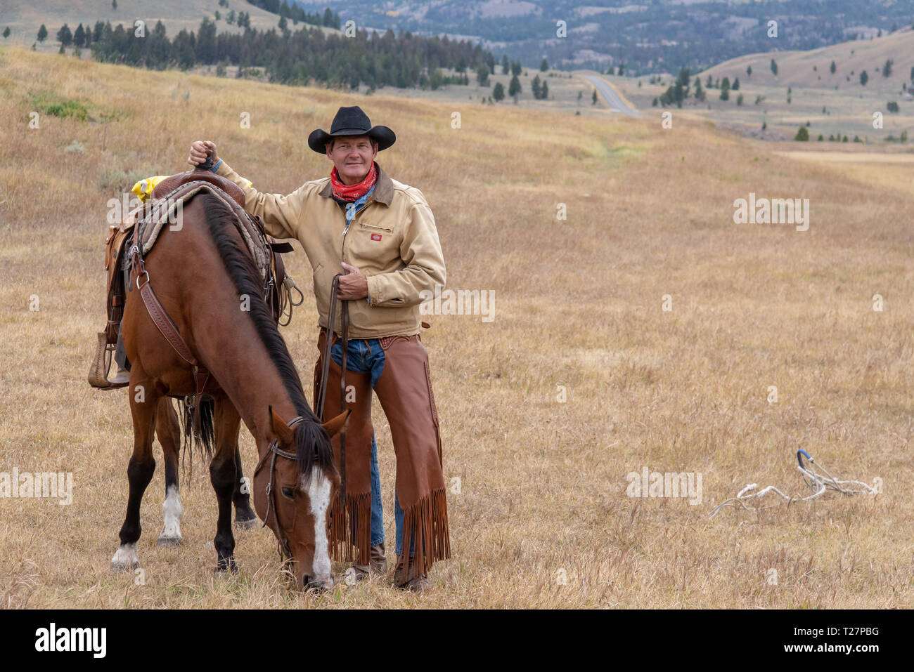 Cowboy and his horse in the high country of Wyoming Stock Photo