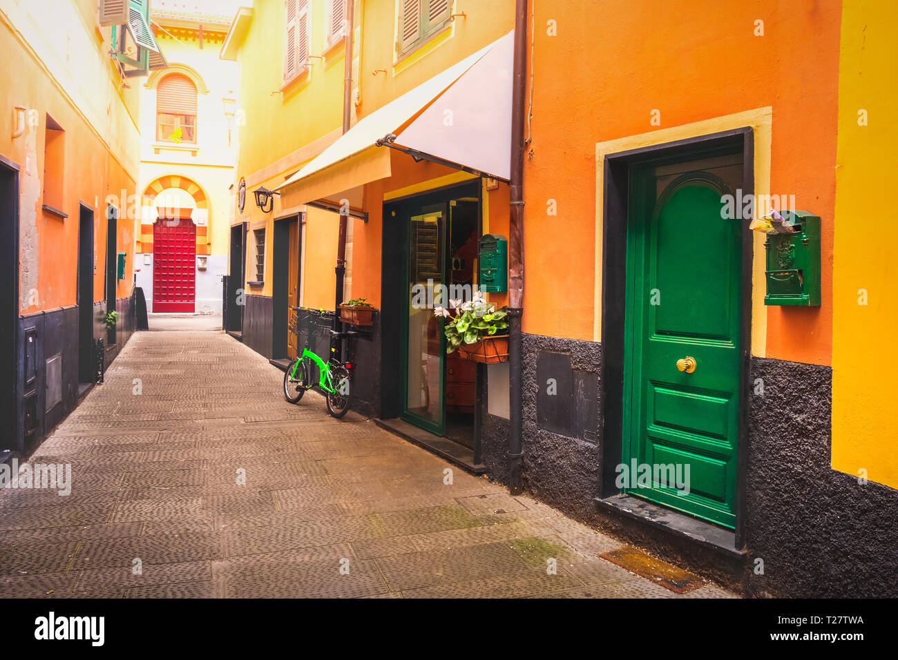 colourful italian alley green door . Stock Photo