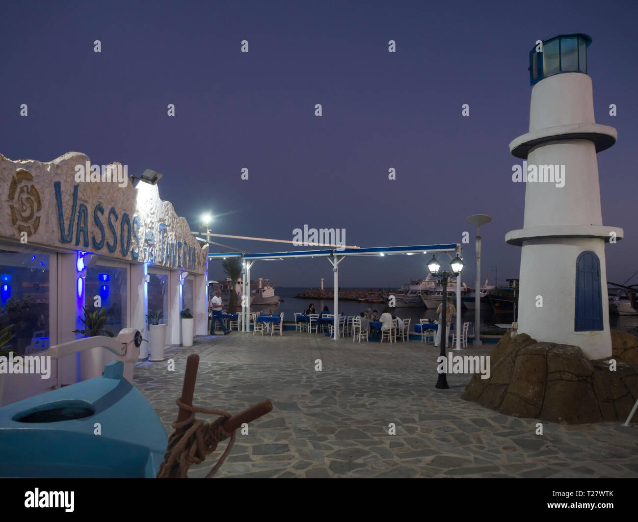Nighttime in the harbour of Ayia Napa Cyprus, The Vassos restaurant offering outdoor and indoor seating Stock Photo