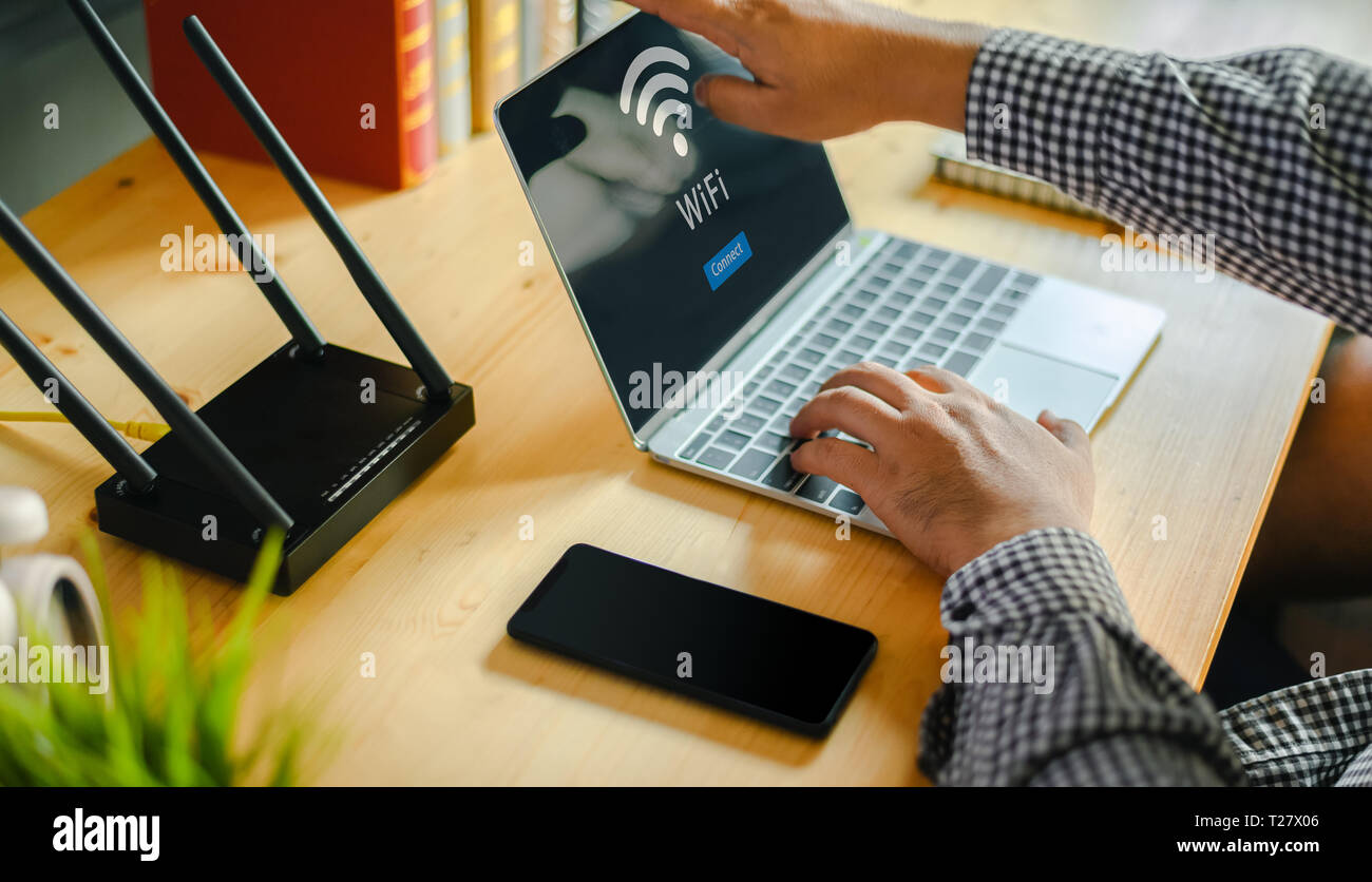 Young man Connecting router wifi On laptop for Internet and social media  Stock Photo - Alamy