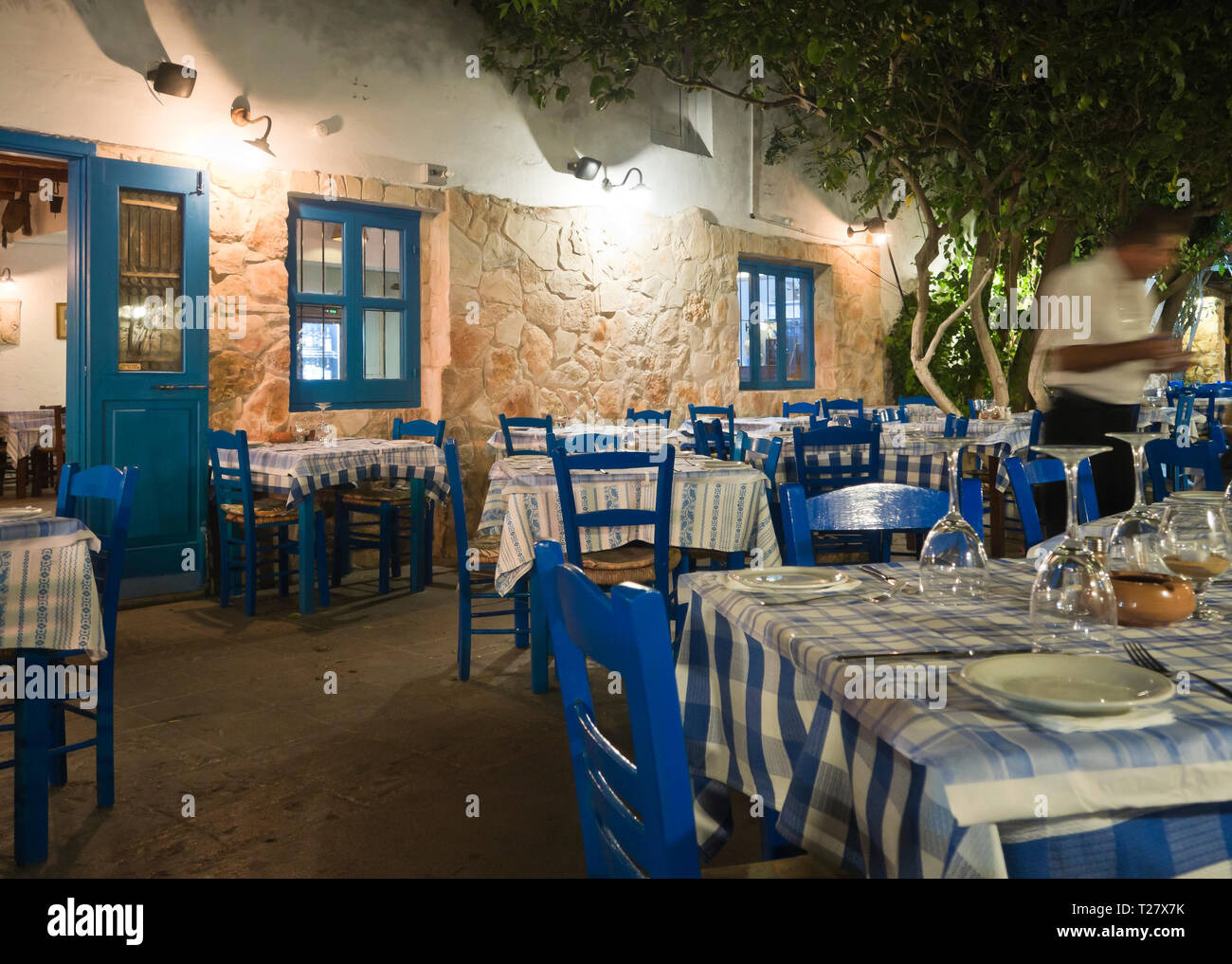 Traditional Cypriot restaurant colored in blue and white with checkered  tablecloth situated in the holiday resort Ayia Napa Stock Photo