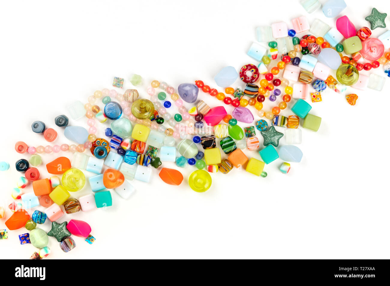 An overhead photo of many different beads, shot from the top on a white background with a place for text Stock Photo