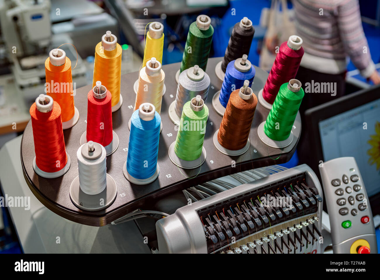 Automatic industrial sewing machine for stitch by digital pattern. Modern textile industry. Stock Photo