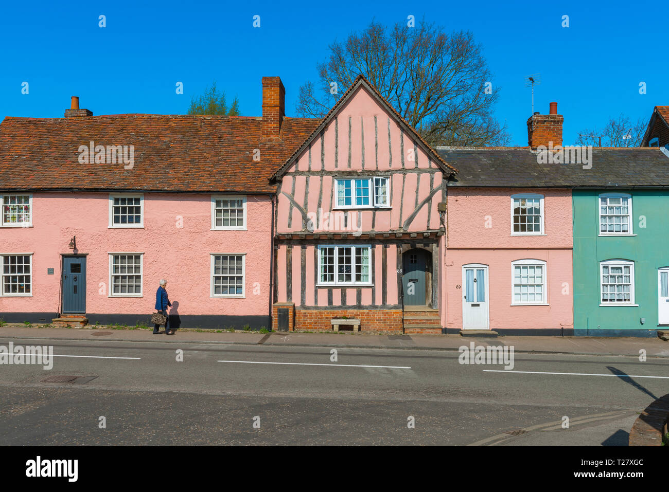 Suffolk pink, view in summer of historic buildings in Lavenham High Street  painted a characteristic pink colour typical of old Suffolk buildings, UK. Stock Photo