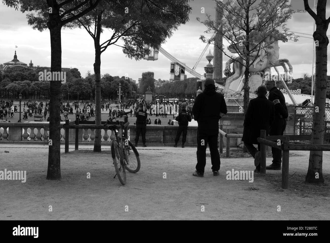 Security officers monitoring civilian gathering, Paris France Stock Photo