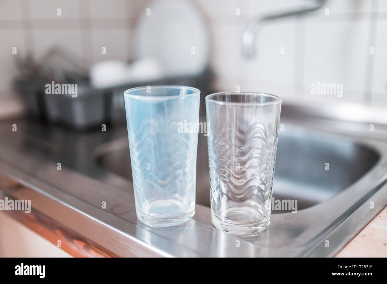 Dirty and clean glass cups on a kitchen sink Stock Photo Alamy