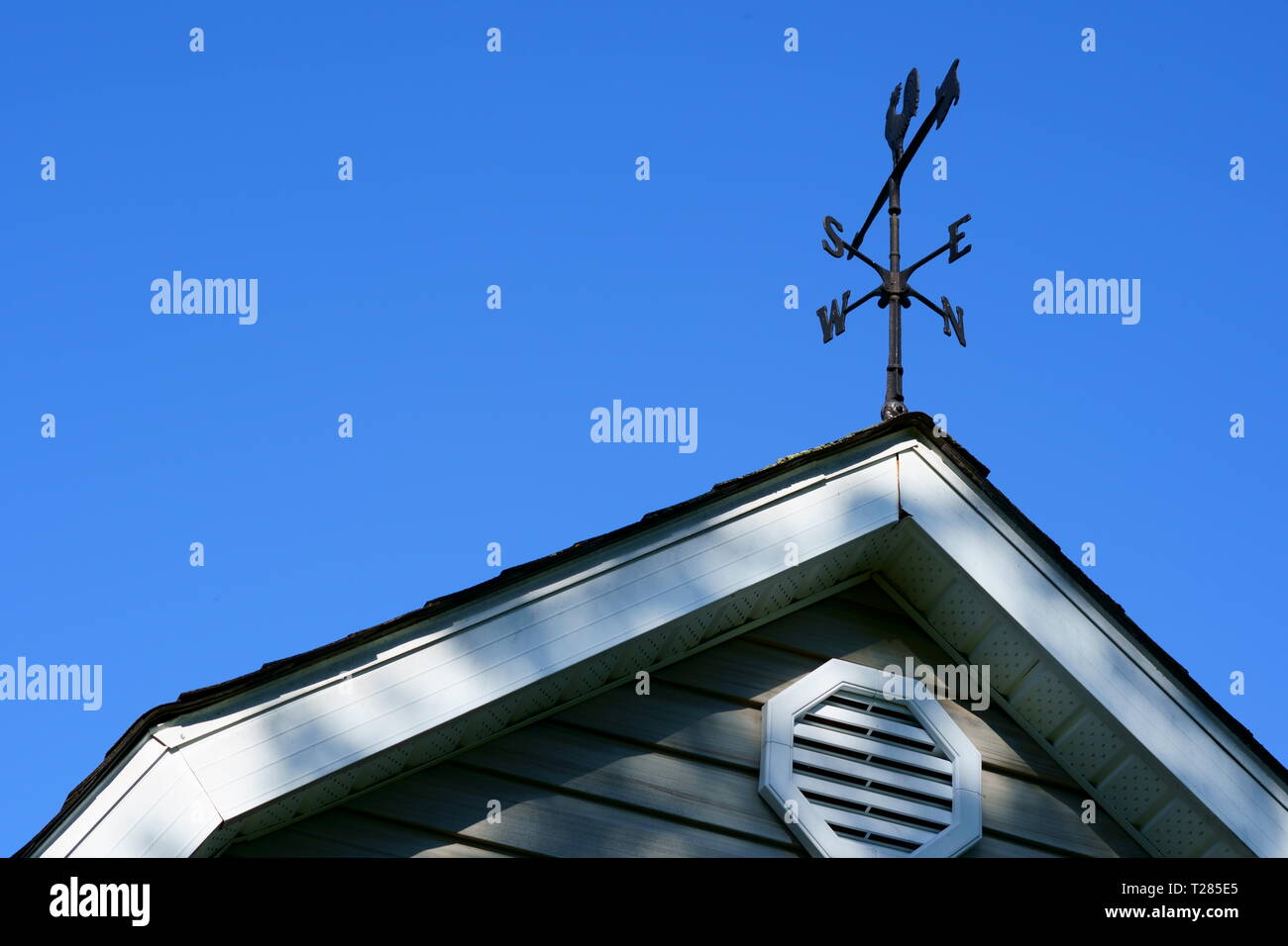 The four cardinal point on the top of a barn with blue sky. Stock Photo
