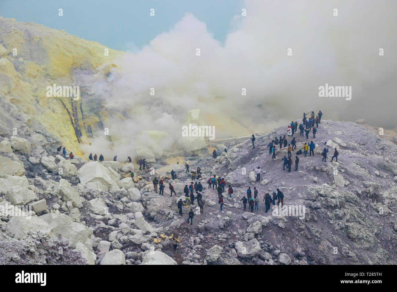 View of the Kawah Ijen crater  and crowded with tourists and with toxic sulferic gases emerging from the bottom. Java, Indonesia. Stock Photo
