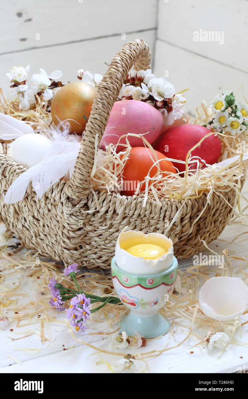 Easter still life with painted eggs and flowers on a white background ...