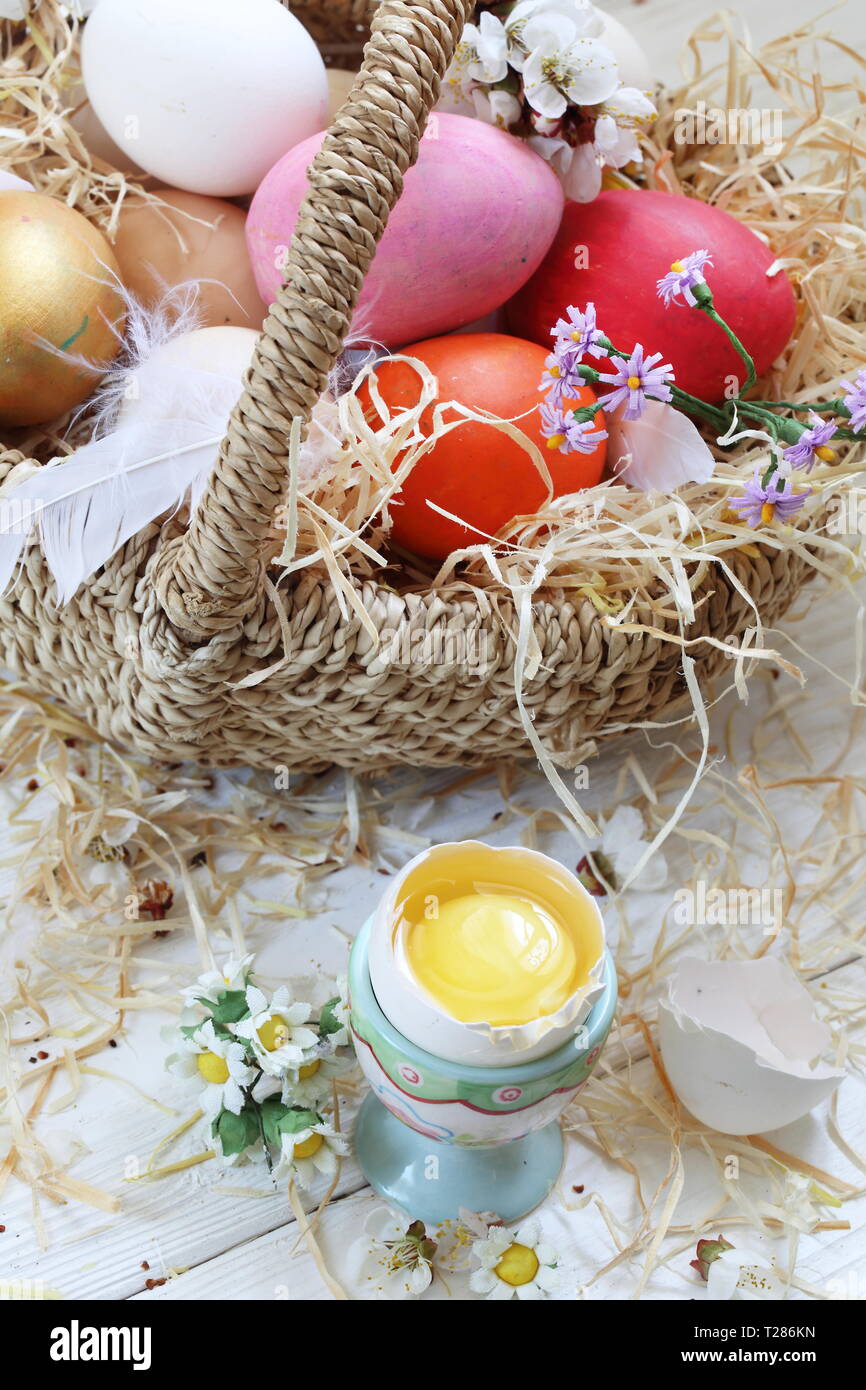 Easter still life with painted eggs and flowers on a white background ...