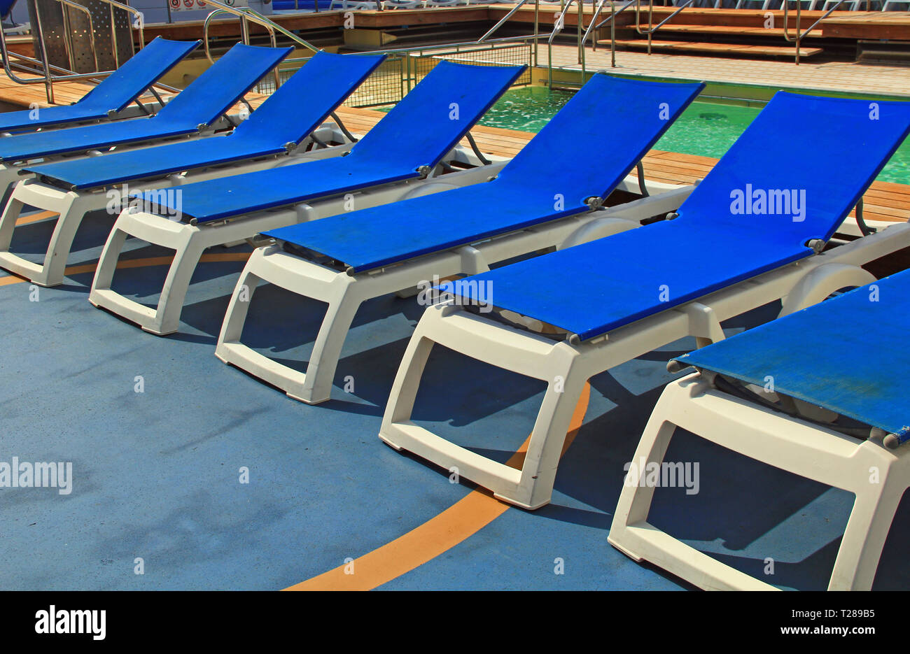 Blue Pool Deck Chairs on a Cruise Ship Stock Photo