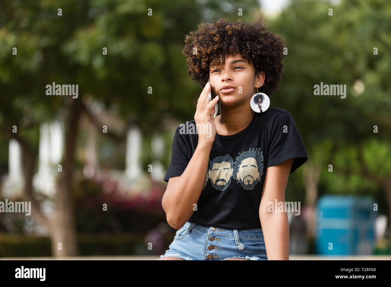 Outdoor portrait of a Young black African American young woman speaking ...