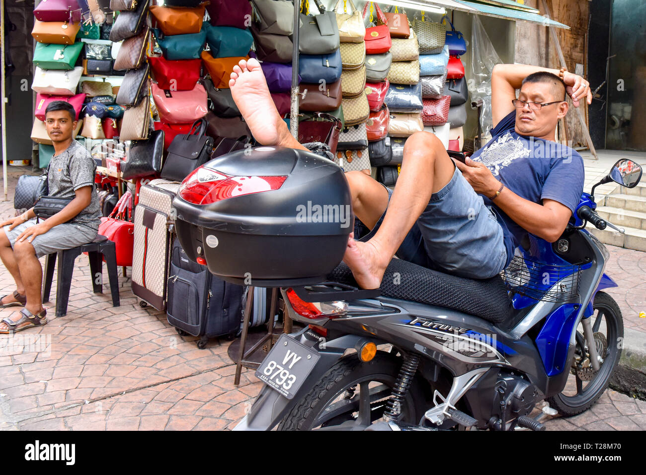 Street vendor Relaxing Chinatown Kuala Lumpur, Malaysia Stock Photo