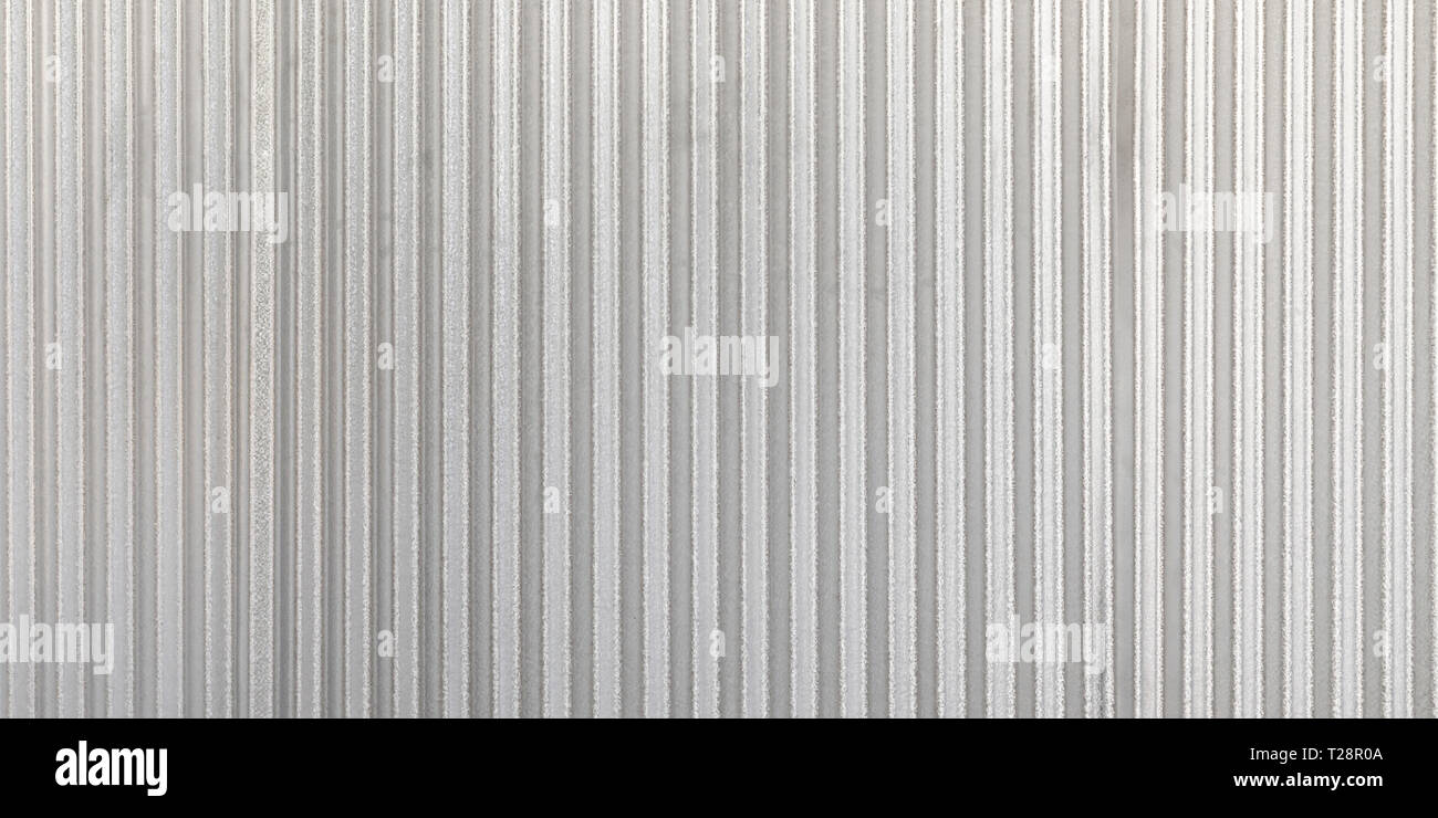 The corrugated grey metal panorama wall background. Rusty zinc grunge texture and background. Stock Photo