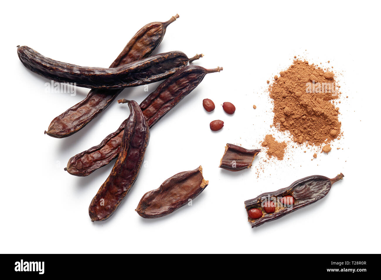 Carob bean pods, seeds and powder on white background Stock Photo