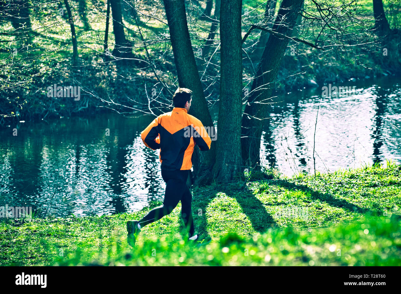 man running along a river Stock Photo