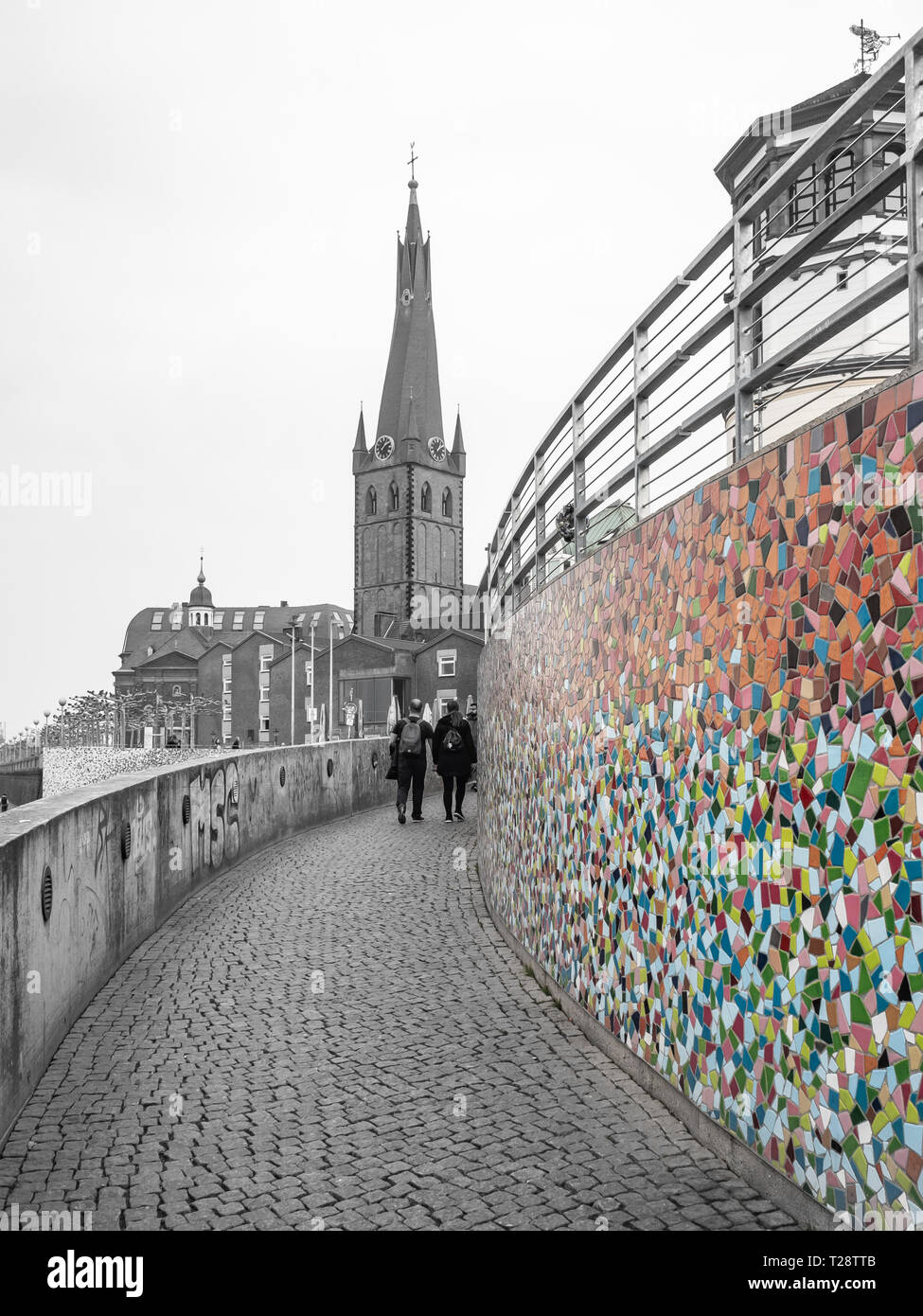 Düsseldorf, Germany, 23 March 2019. People walking up to old town in front of colorful Mosaic on the promenade on the bank of river Rhine. Stock Photo