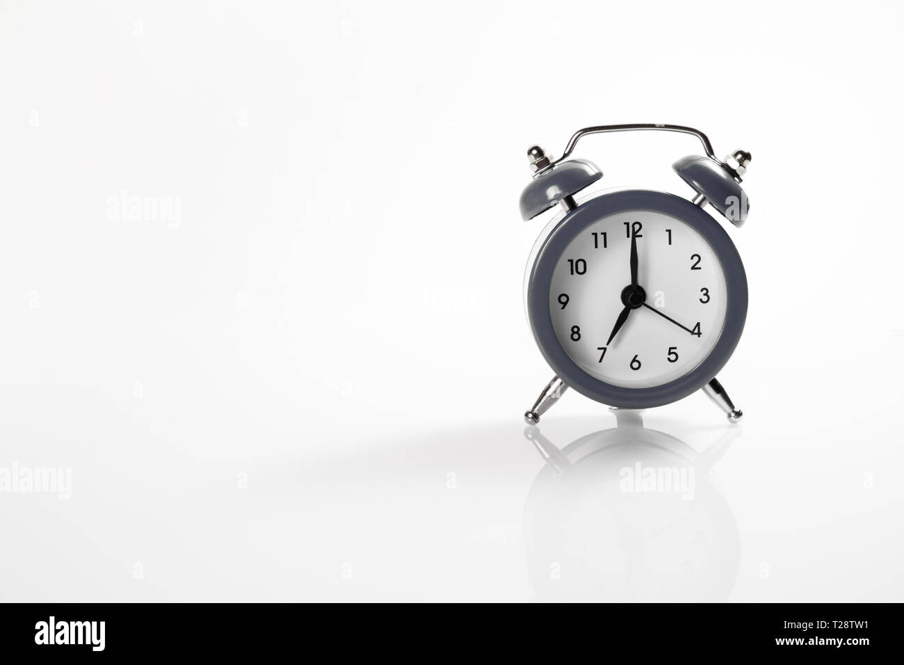 Dark alarm clock with shadow and space for your presentation text