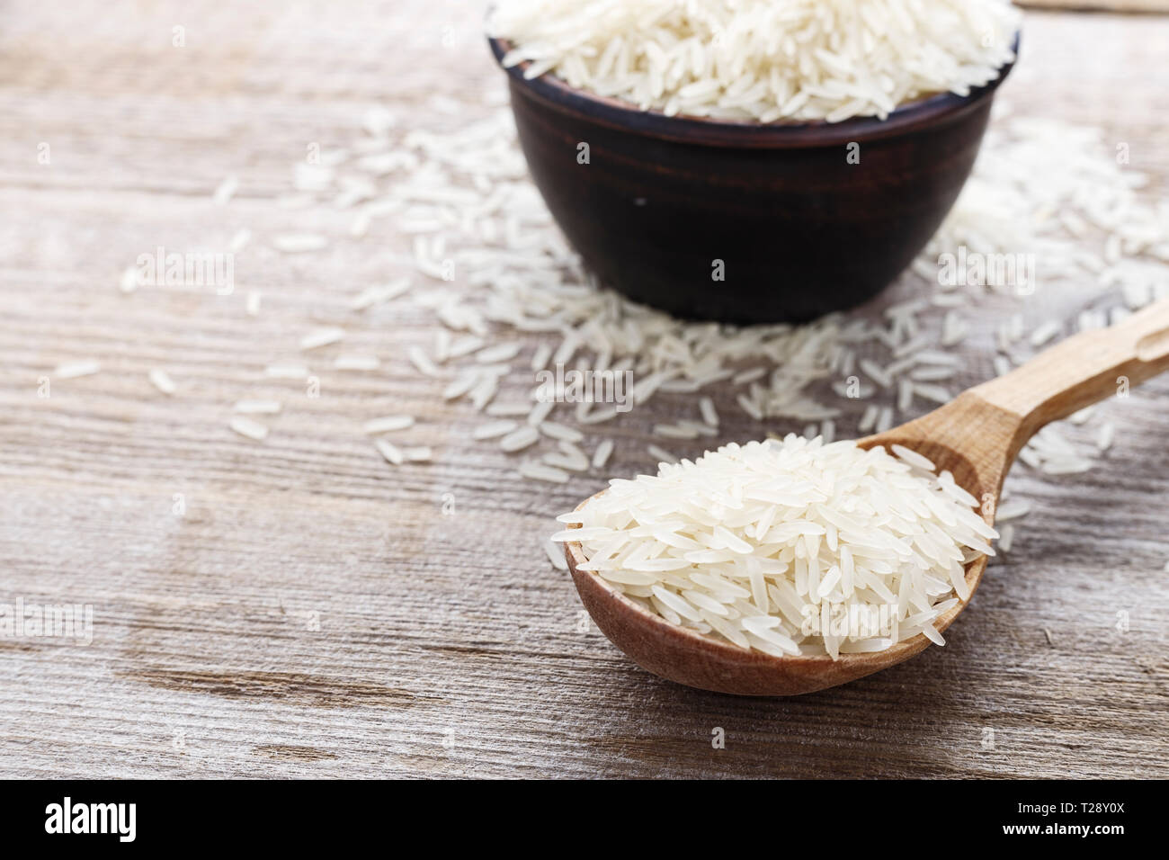 Raw white rice in a spoon. healthy food Stock Photo - Alamy