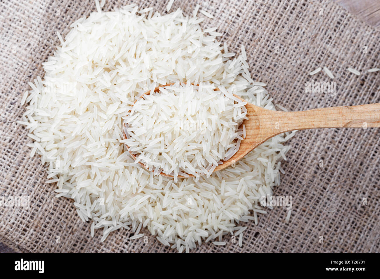 Raw white rice in a spoon. healthy food Stock Photo - Alamy