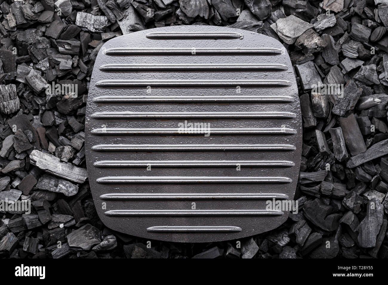 net grill pan stands on the coals. space for text Stock Photo