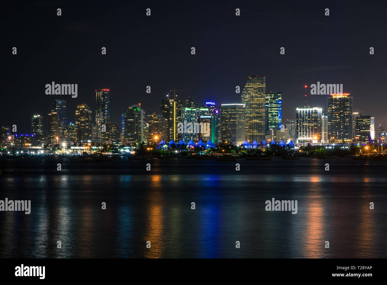 Night Scenery of Miami City Scape across the water. Neon lit skyscrpaers Stock Photo