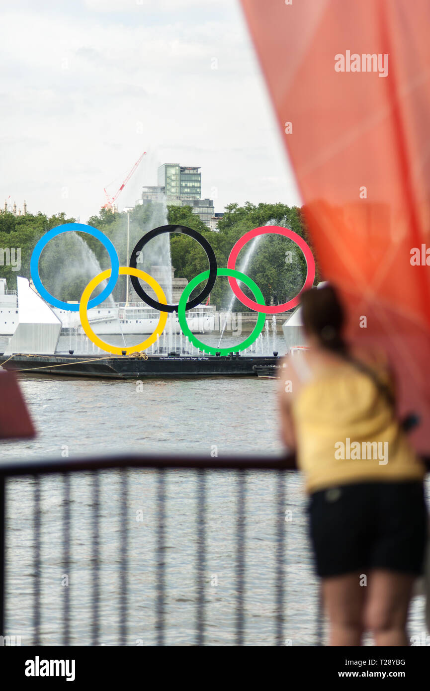 Spectators view the interactive, 'Rings on the River' exhibit, on the River Thames during the London Olympic Games 2012. Stock Photo