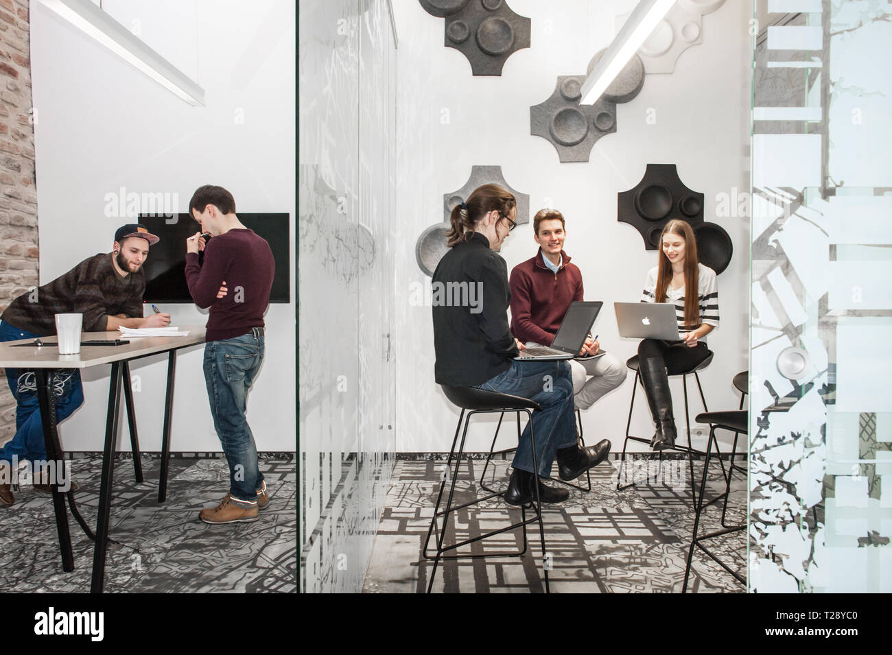 People engaged with technology in a business environment Stock Photo