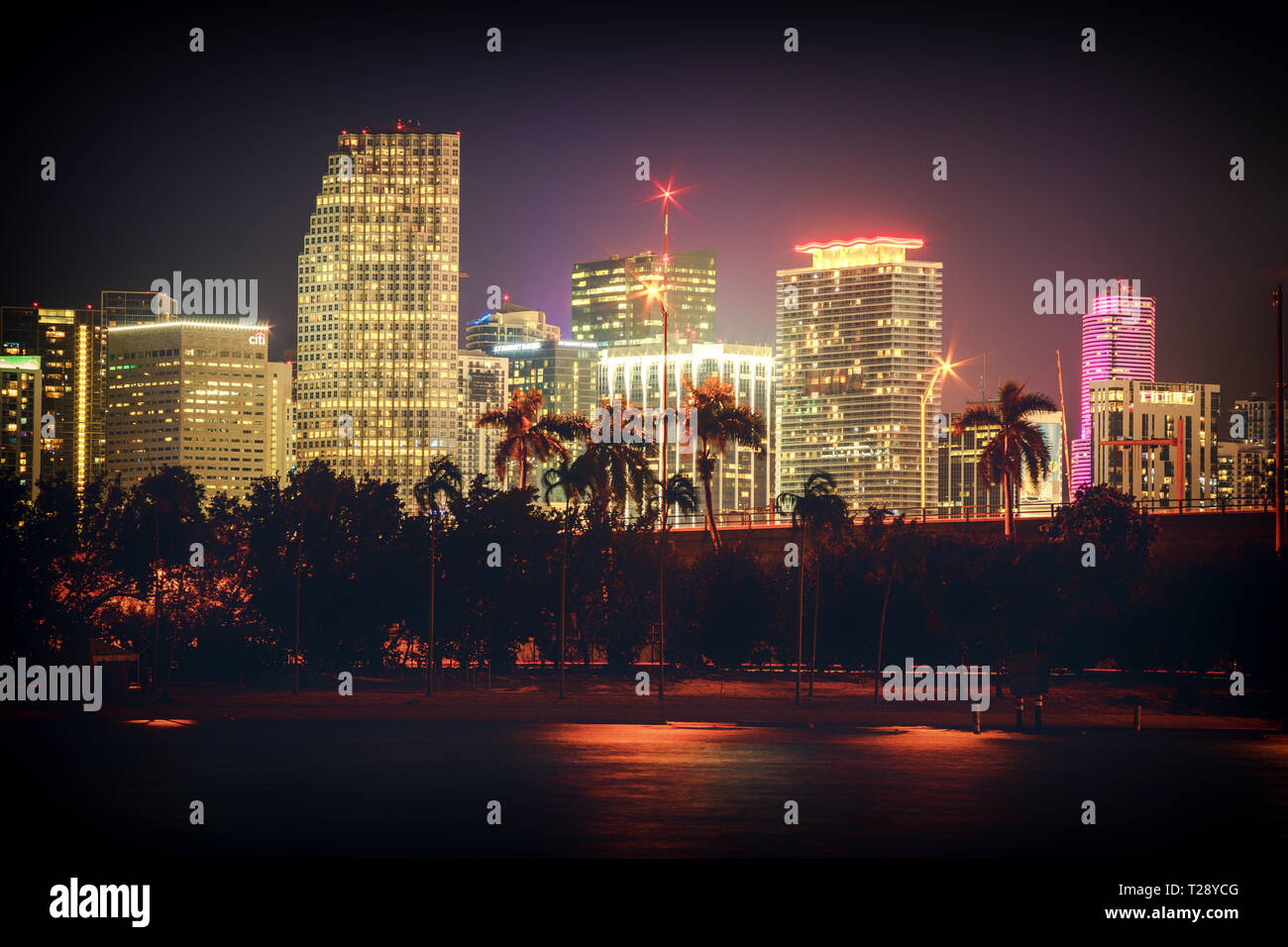 Night Scenery of Miami City Scape across the water. Neon lit skyscrpaers Stock Photo