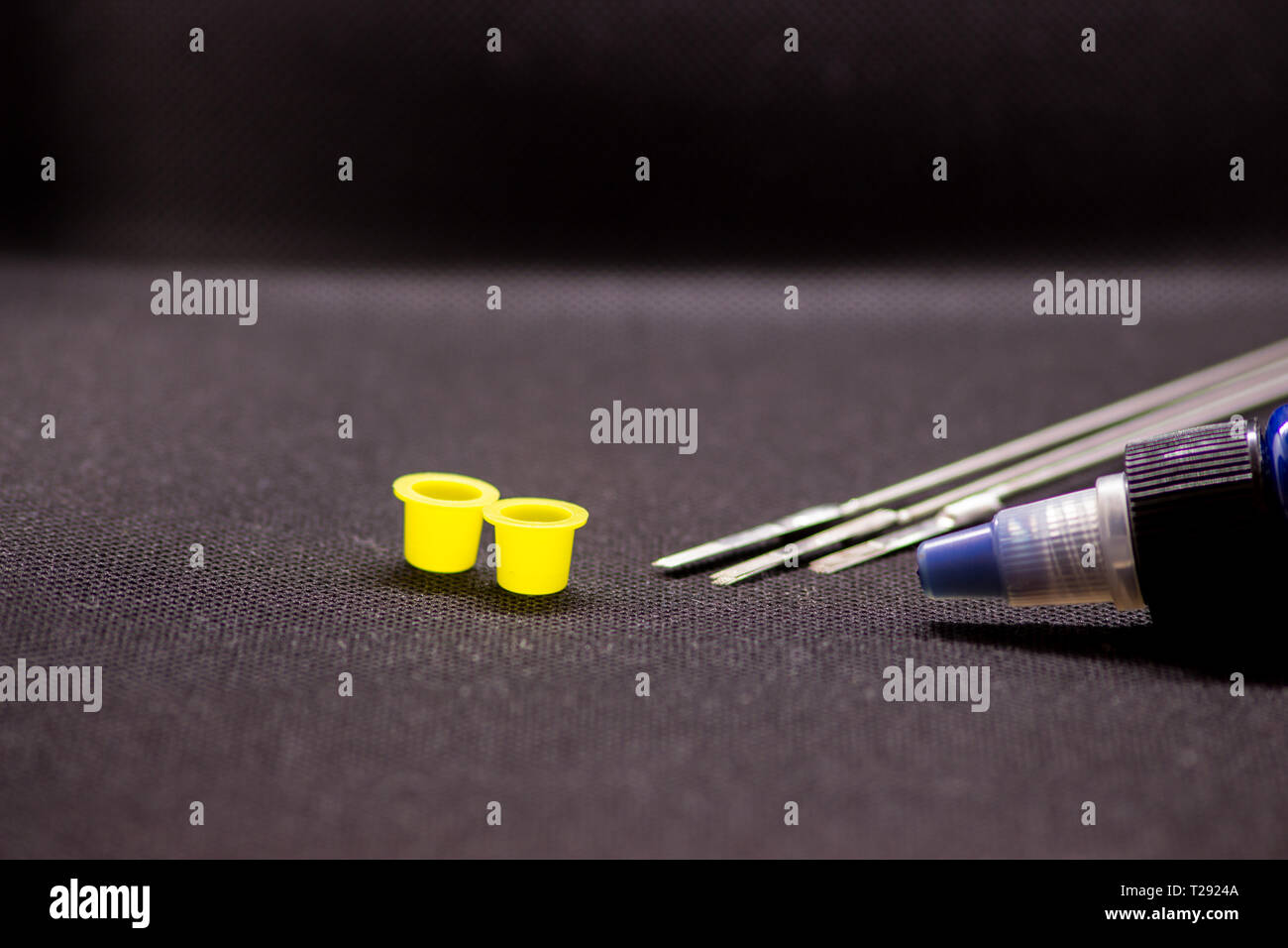 Tattoo equipment, tattoo ink and needle on black background Stock Photo