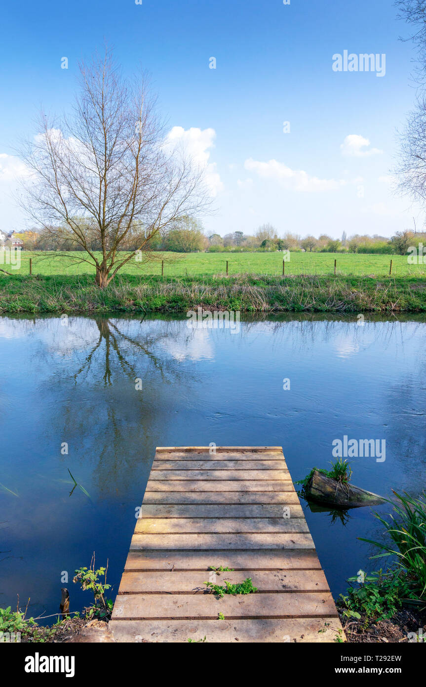 Small wooden jetty at the edge of a river Stock Photo