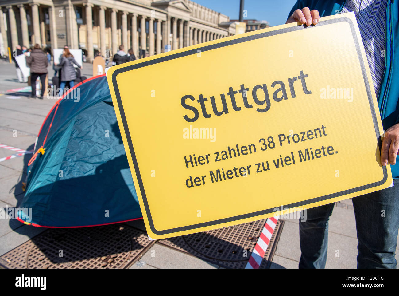 Stuttgart, Germany. 28th Mar, 2019. An employee of the economic policy of the German Confederation of Trade Unions (DGB) in Baden-Württemberg and SPD member of the Bundestag holds a sign with the inscription 'Stuttgart - 38 percent of tenants pay too much rent here'. The campaign aims to draw attention to the problem of rising rents, a lack of social housing and a lack of inexpensive building land. Credit: Fabian Sommer/dpa/Alamy Live News Stock Photo