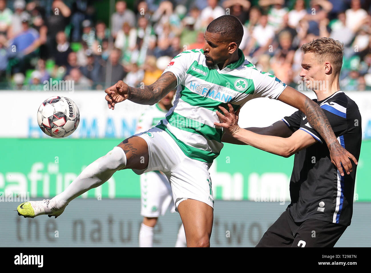 Furth, Germany. 31st Mar, 2019. Soccer: 2nd Bundesliga, SpVgg Greuther Fürth - Arminia Bielefeld, 27th matchday, at the Sportpark Ronhof Thomas Sommer. Daniel Keita-Ruel (l) from Fürth fights for the ball with Amos Pieper from Bielefeld. Photo: Daniel Karmann/dpa - IMPORTANT NOTE: In accordance with the requirements of the DFL Deutsche Fußball Liga or the DFB Deutscher Fußball-Bund, it is prohibited to use or have used photographs taken in the stadium and/or the match in the form of sequence images and/or video-like photo sequences. Credit: dpa picture alliance/Alamy Live News Stock Photo