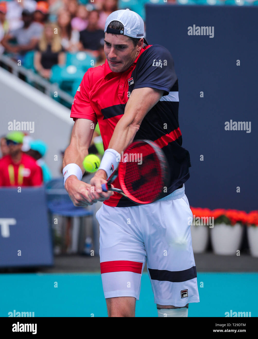 Miami Gardens, Florida, USA. 31st Mar, 2019. John Isner, of the United States, hits a backhand against Roger Federer, of Switzerland, in the Men's Singles final of the 2019 Miami Open Presented by Itau professional tennis tournament, played at the Hardrock Stadium in Miami Gardens, Florida, USA. Federer won 6-1, 6-4. Mario Houben/CSM/Alamy Live News Stock Photo