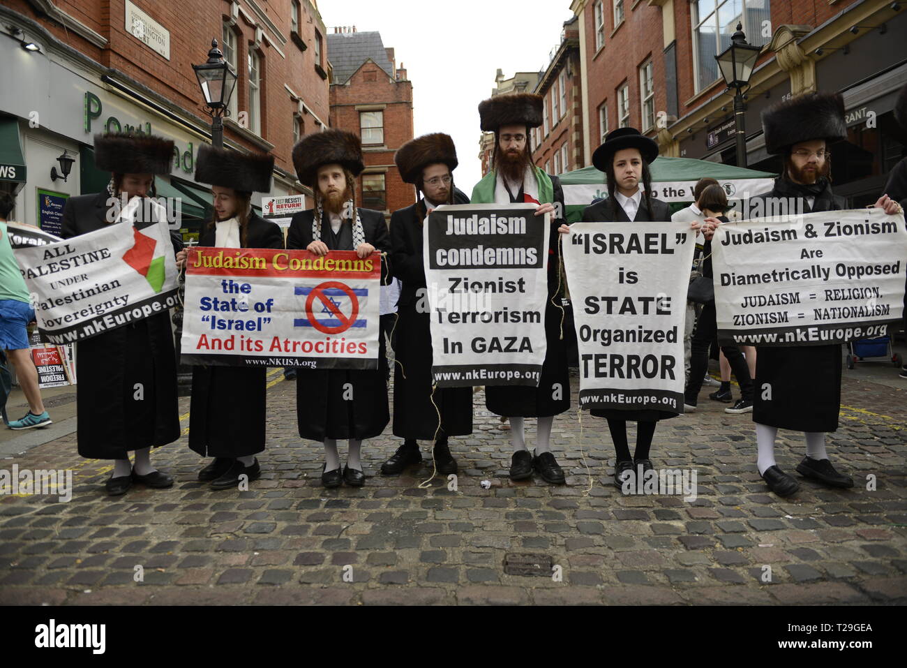 Orthodox Jews are seen holding placards during the Exist, Resist, Return Rally for Palestine in London. People gather outside the Israeli embassy in London to demonstrate against the Israeli government, and to demand respect for Palestinians’ fundamental rights to exist, resist and return. Palestinians are calling for global protests to support their right to come back to their villages. Rally was organized by Palestine Solidarity Campaign, Stop the War Coalition, Palestinian Forum in Britain, Friends of Al- Aqsa, and Muslim Association of Britain. Stock Photo