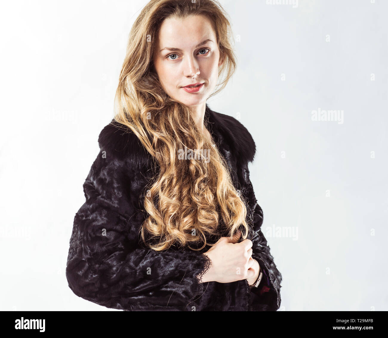 portrait of young business woman in a black coat on a white background ...