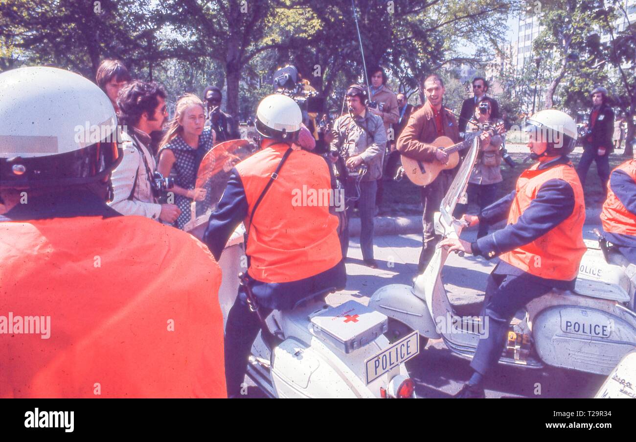 During the 1971 May Day Protests against the Vietnam War, protesters in hippie attire face off against several motorcycle police officers, in Washington, DC, May 1971. () Stock Photo