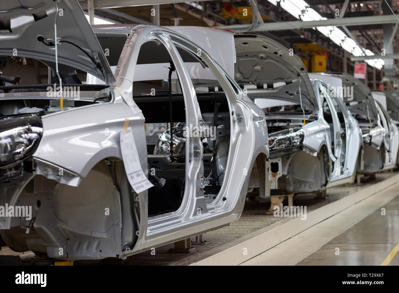 Russia, Izhevsk - December 15, 2018: LADA Automobile Plant Izhevsk, part of the AVTOVAZ Group. The bodies of new car on the conveyor line. Assembly sh Stock Photo