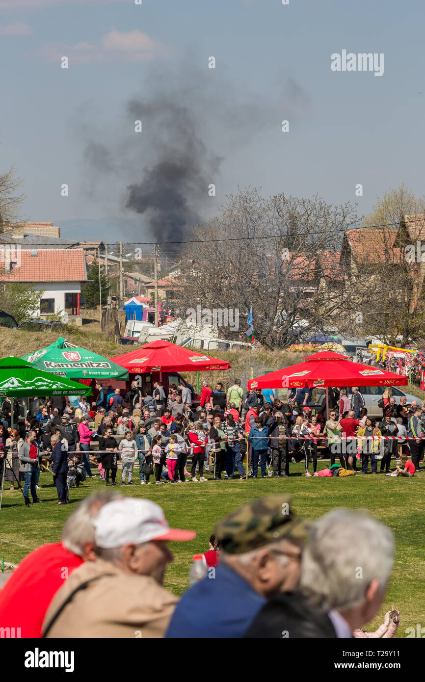 VARVARA, BULGARIA - MARCH 24, 2019: Moment from National Festival Dervish Varvara presents traditions of Bulgarian Kuker Games. Fire with thick black  Stock Photo