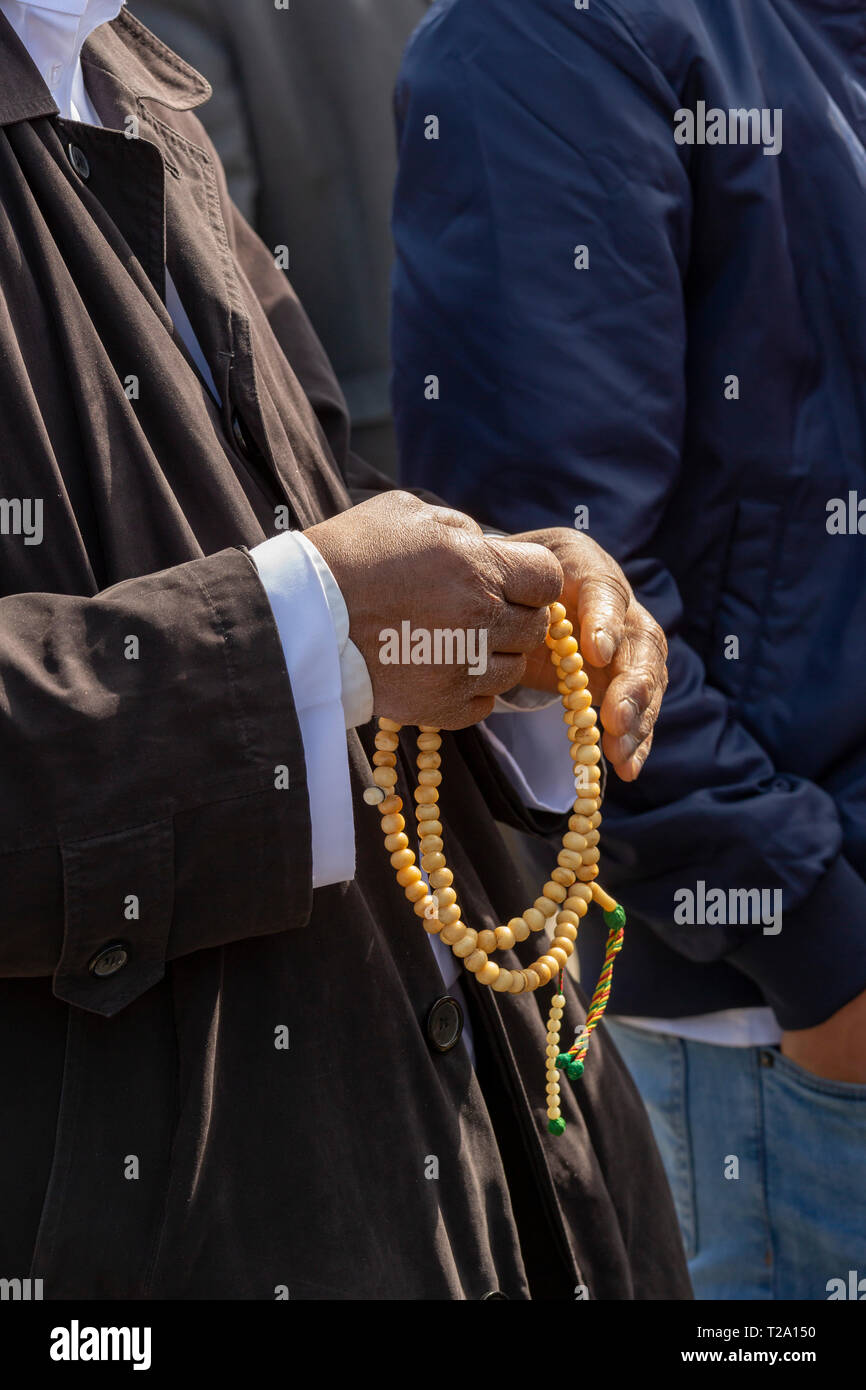 Detroit, Michigan - A Muslim man holds a misbaá¸¥ah, Islamic prayer beads. The misbahah is used when performing dhikr--the repetition of short phrases Stock Photo