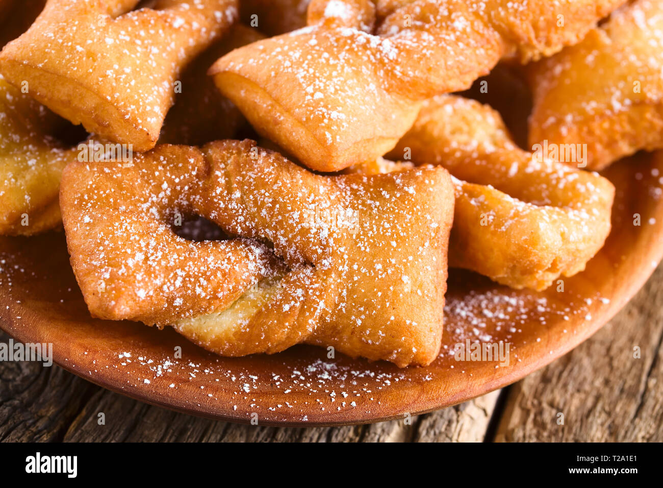 Traditional Chilean sweet calzones rotos deep-fried pastries sprinkled with  powdered sugar served on wooden plate (Selective Focus Stock Photo - Alamy