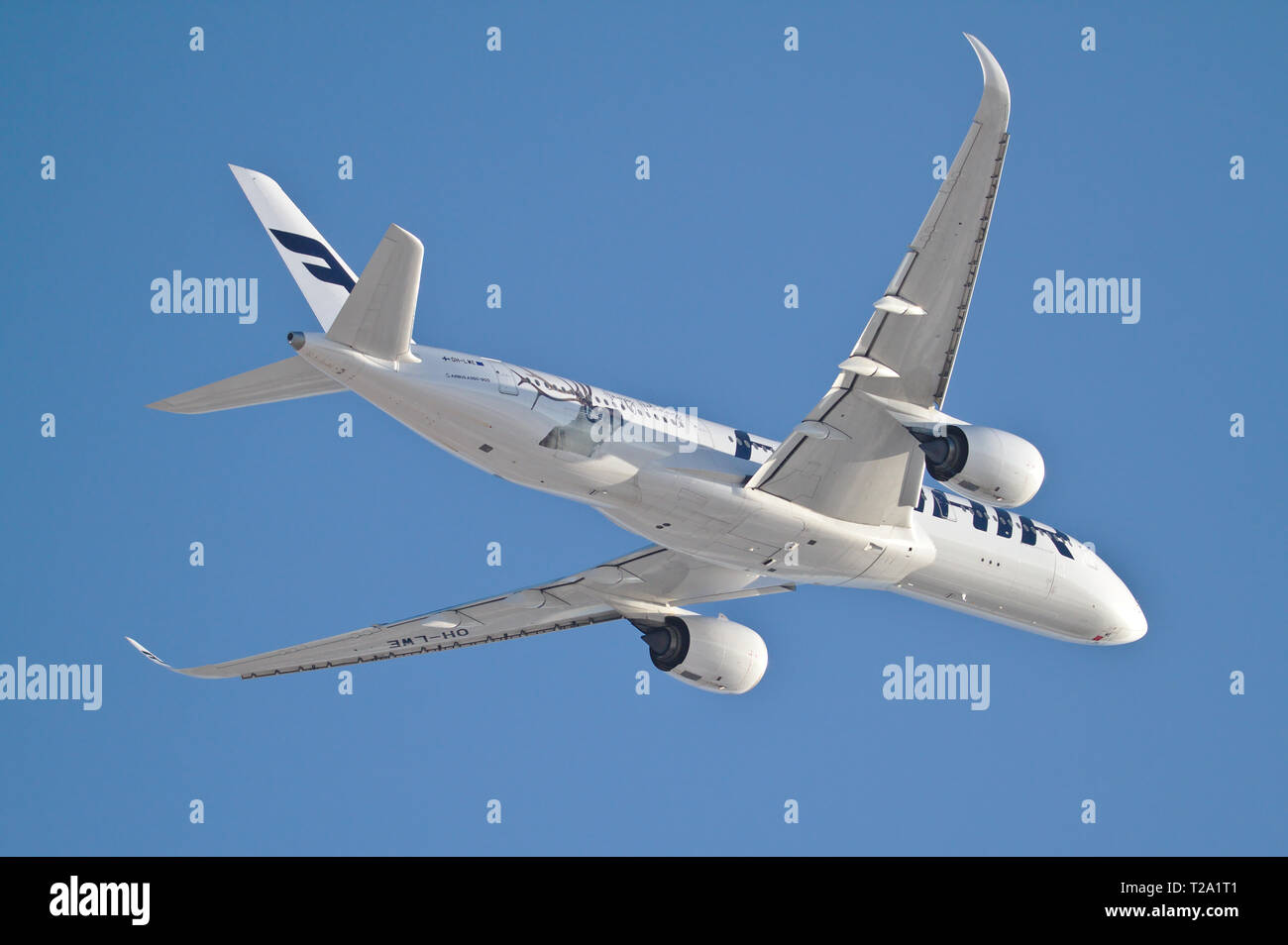 White Finnair's Airbus A350-900 flying over in sunny weather. 16.06.2018 Vantaa, Finland Stock Photo