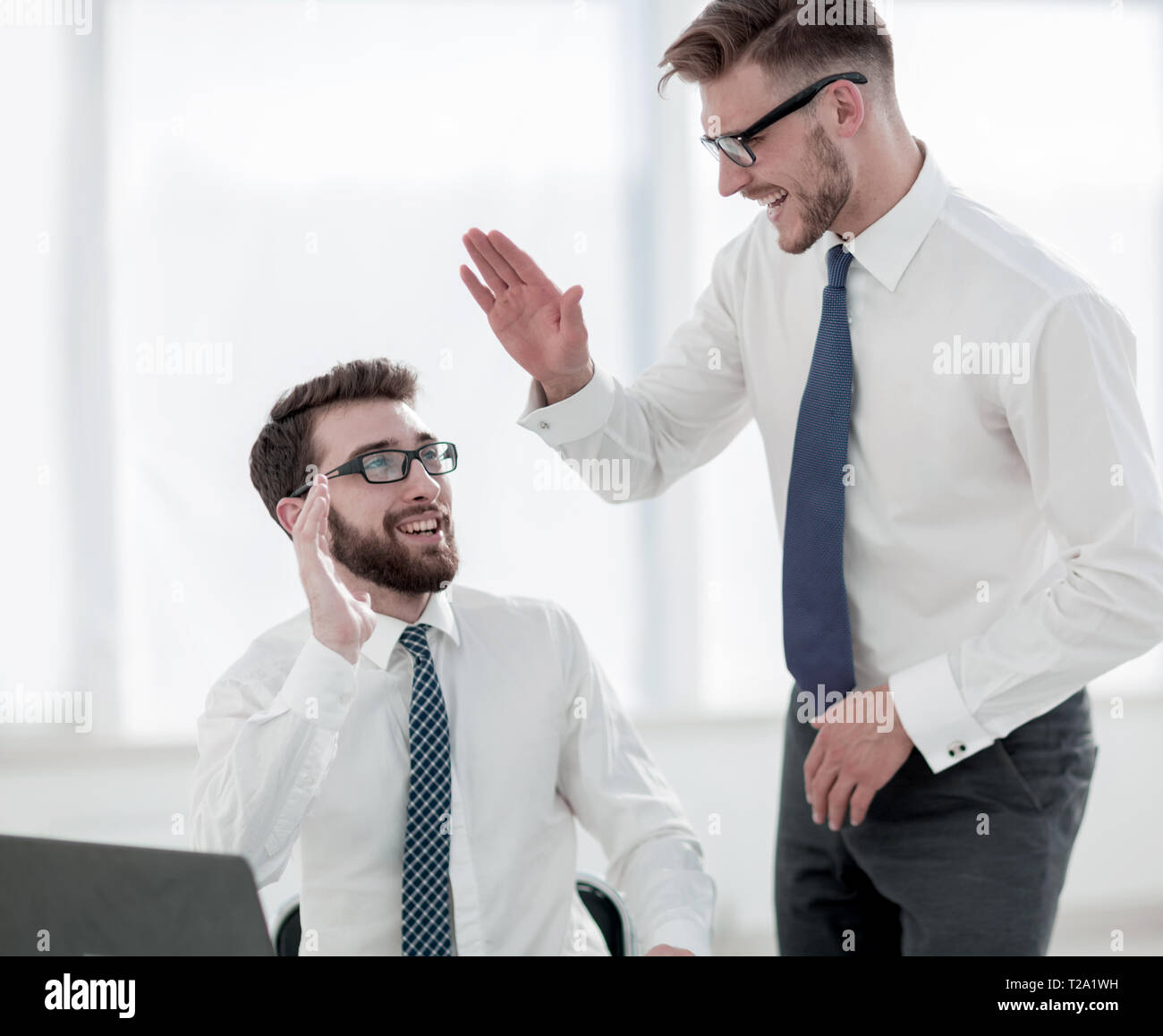close up.two employees giving each other a high five Stock Photo - Alamy