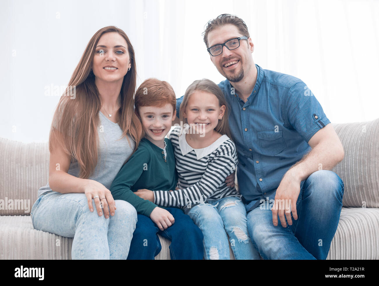 happy family sitting on the couch in the living room Stock Photo - Alamy