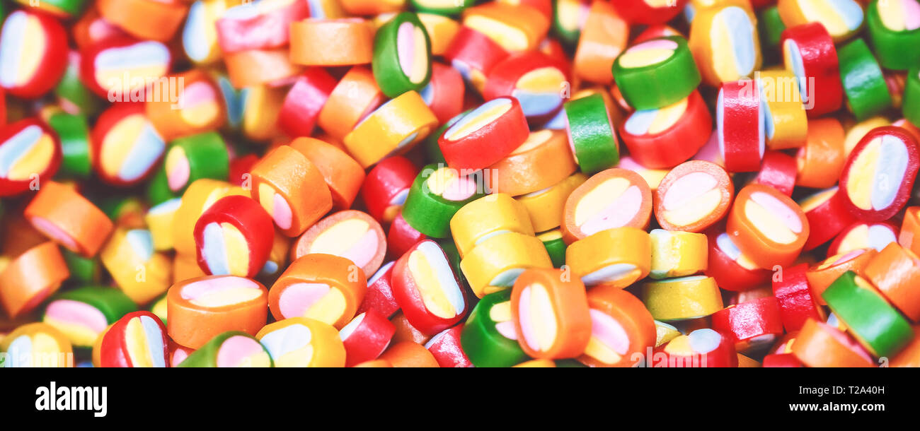 Colorful lollipops and different colored round candy. Top view. Stock Photo