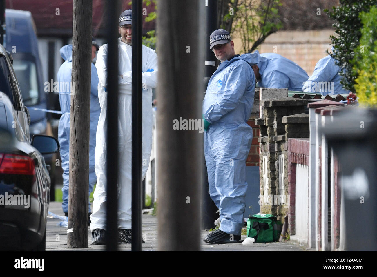 Police forensics officers on Aberdeen Road in north London, after four stabbings between Saturday evening and Sunday morning in the Edmonton area, which police are treating as potentially linked. Stock Photo