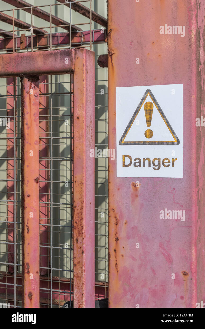 Fading Danger Warning Sign In An Industrial Area Factory Warning Signs Stock Photo Alamy