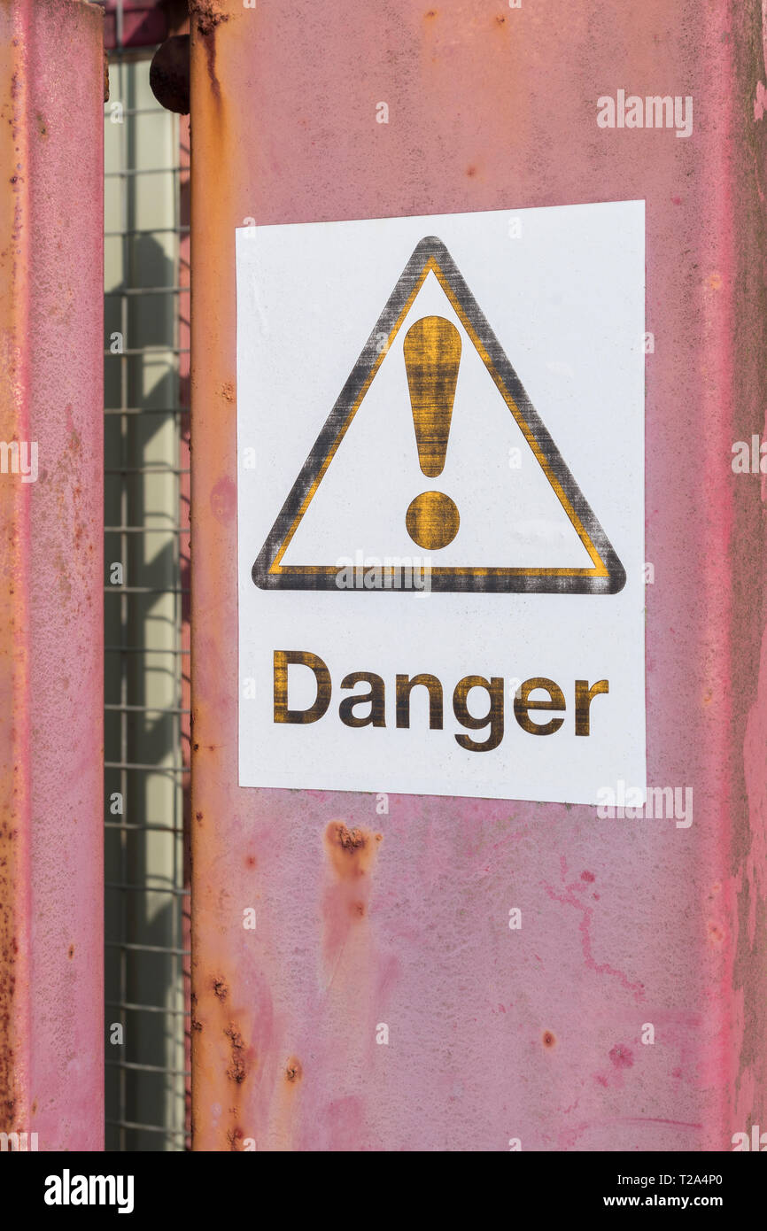 Fading Danger Warning Sign In An Industrial Area Factory Warning Signs Stock Photo Alamy