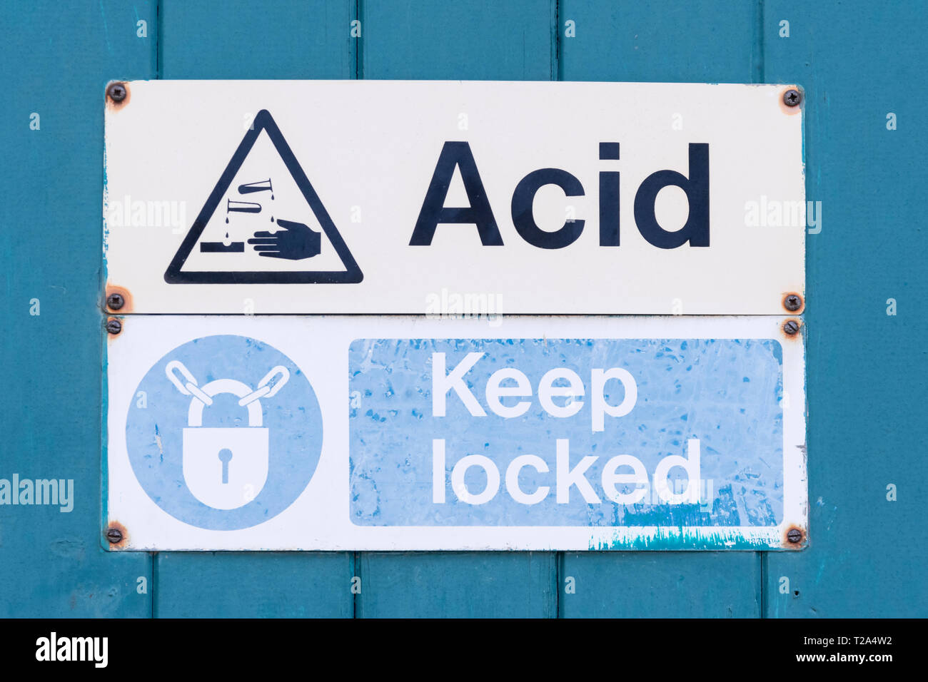 Dangerous chemicals / chemical danger warning sign. Chemical burns concept, metaphor chemical burns, factory warning signs, health and safety at work. Stock Photo